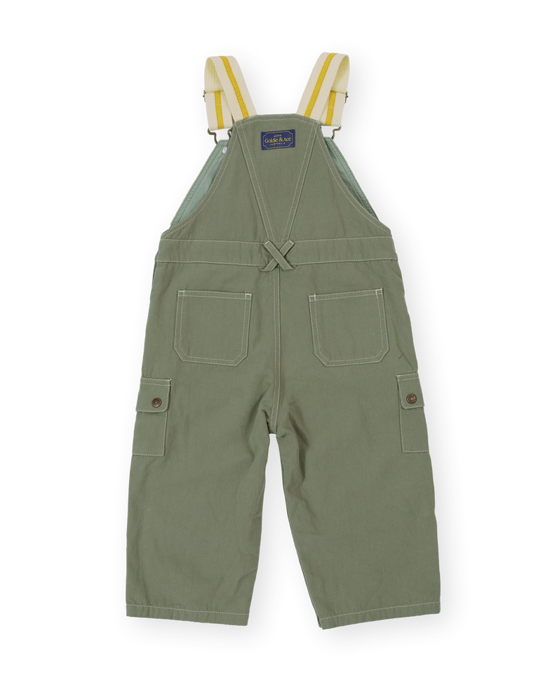 Back view of olive green overalls with crossed straps and back pockets.