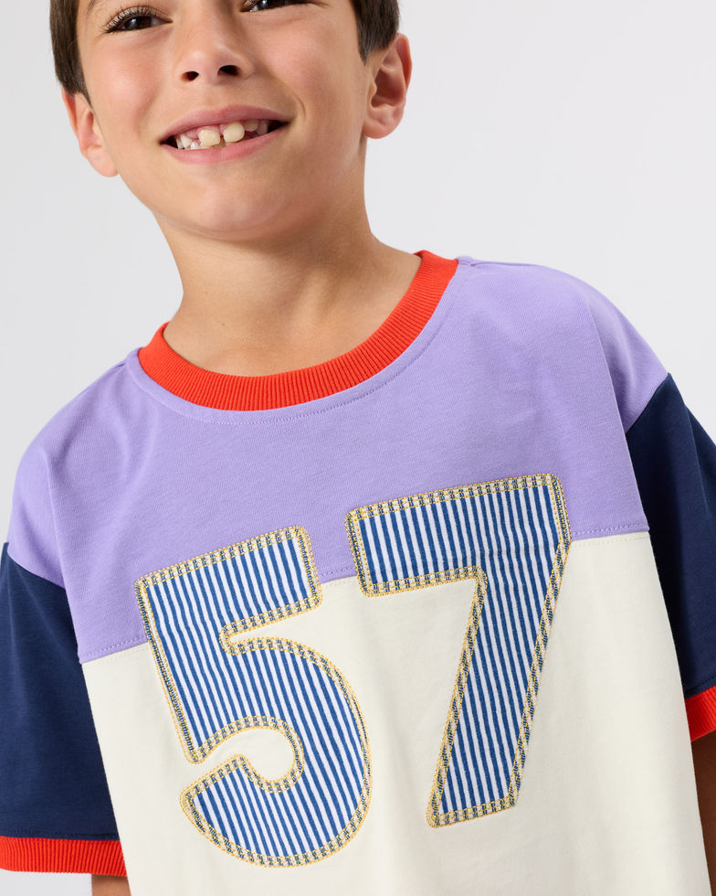 Close-up of the upper part of the “57” T-shirt showing neckline and number detail.
