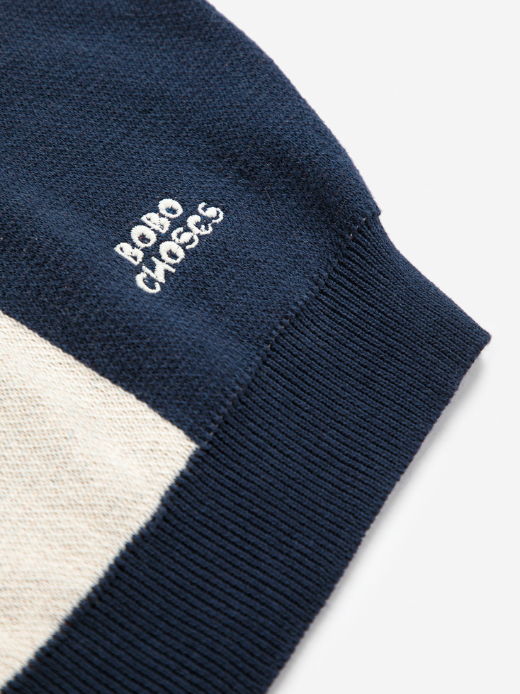 Detail shot of Bobo Choses embroidered logo on sleeve of jumper