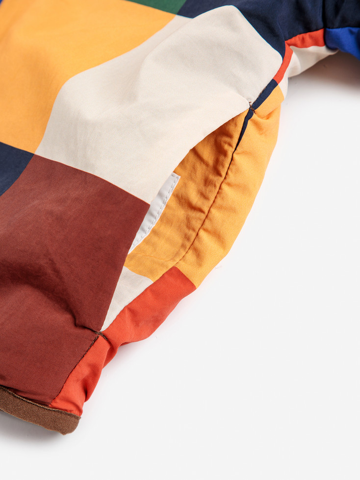 Close-up detail of the multicolor patchwork fabric.