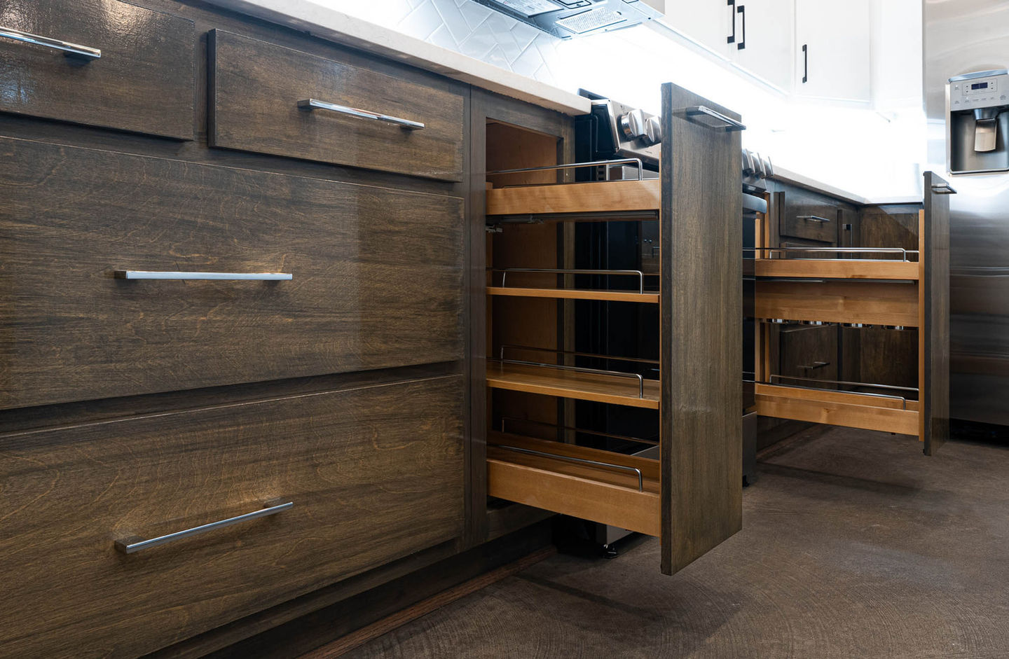 Sleek industrial kitchen cabinets with specialty spice rack pull-out drawers. 