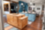 Custom kitchen islands with both stained knotty wood and painted wood together.