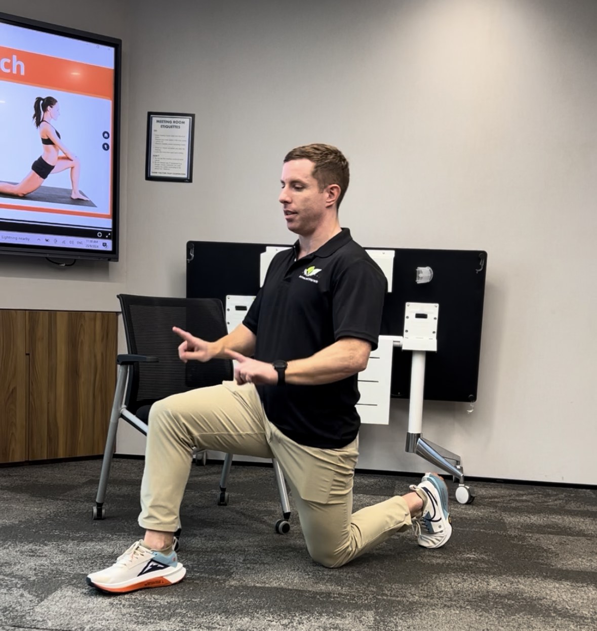 Chiropractor demonstrating a hip flexor stretch