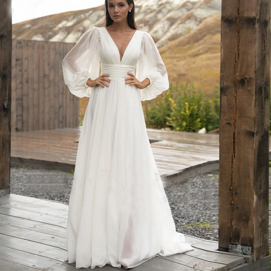 Thumbnail: Elegant Flowy Bohemian Chiffon Wedding Dress with Puff Sleeves and V-Neck