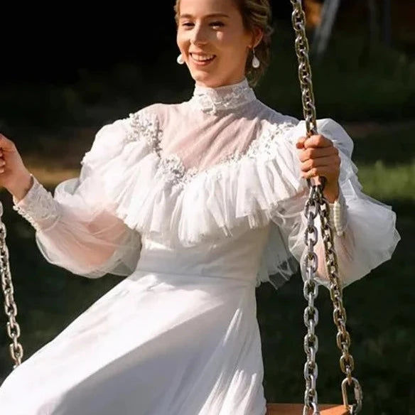 Thumbnail: Vintage Victorian Wedding Dress with High Neck, A-Line Silhouette, and Pearl Emb