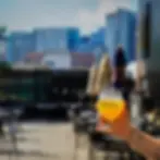 The outside patio view featuring someone holding a drink at Lord Hobo