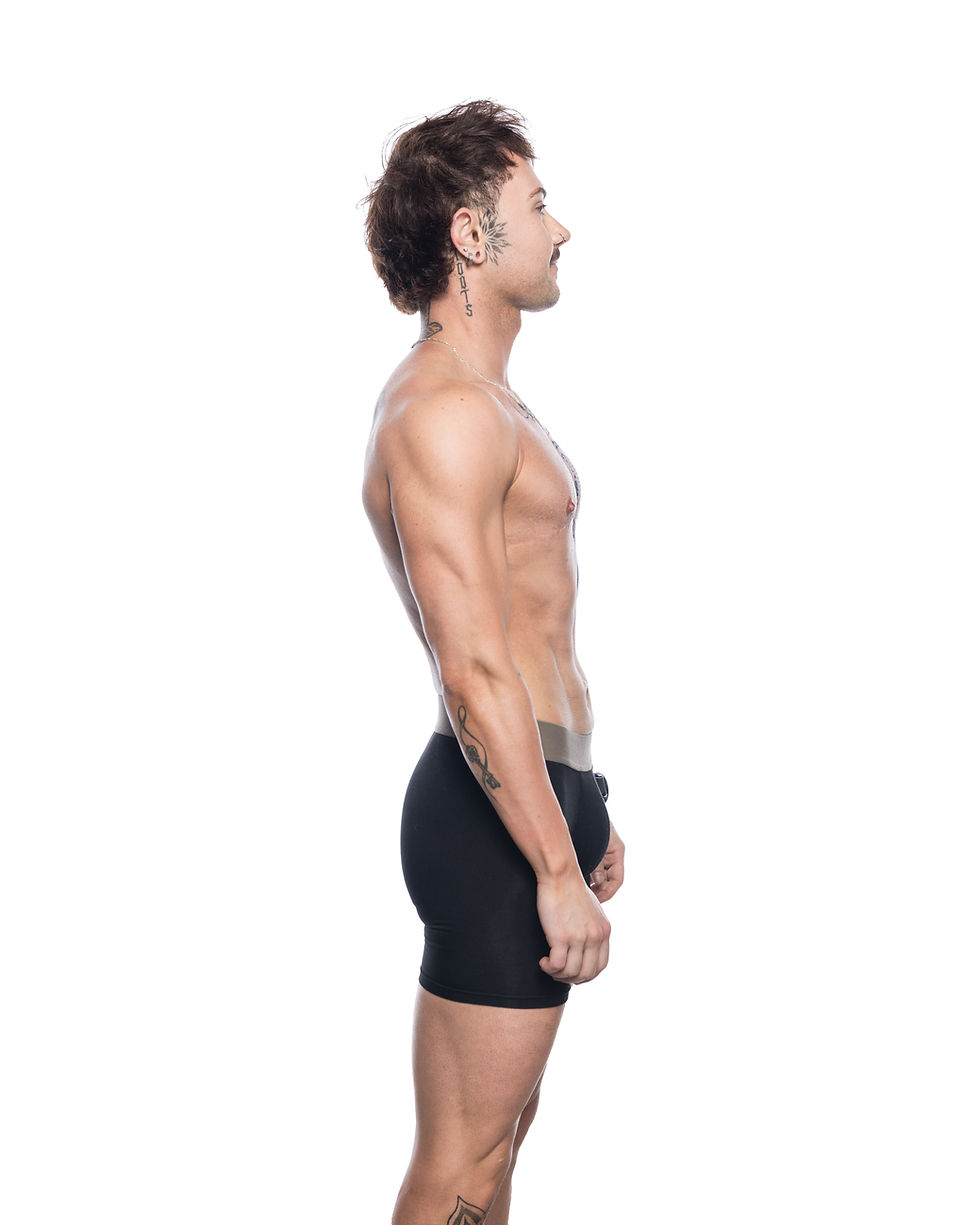 Side View of a muscular transman wearing packing boxers, gender affirming underwear made by Dys4ick