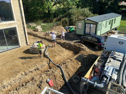 Exterior concrete installation at a domestic property with an external outbuilding