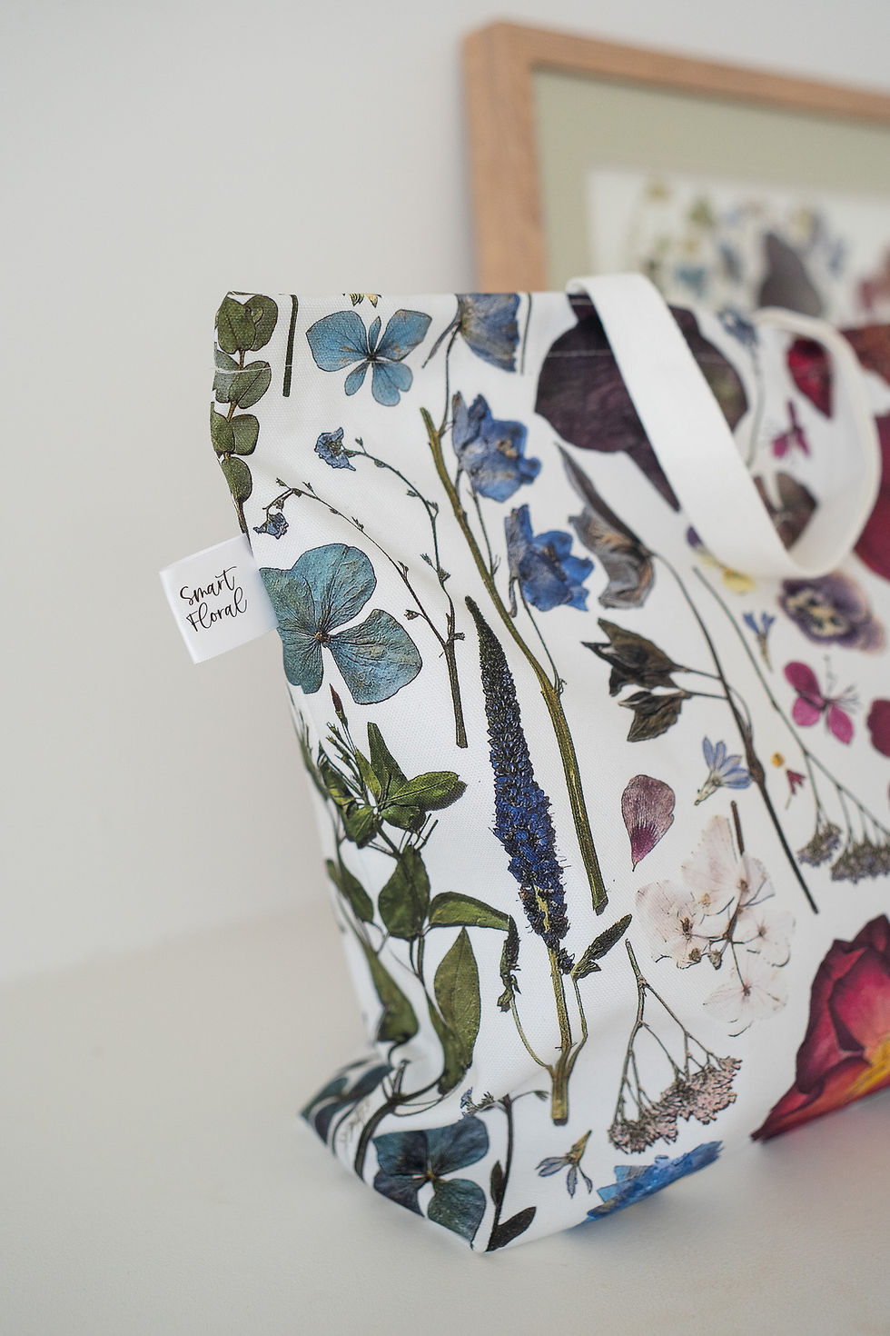 Thumbnail: close up of white multicoloured floral tote bag