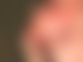 a trans man stroking his beard