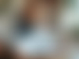 A woman packing Christmas decorations back into a cardboard box