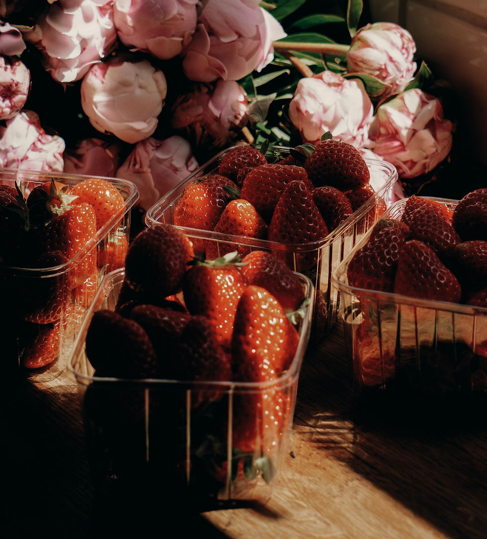 Summer strawberries and peonies in the warm glow of summer sun