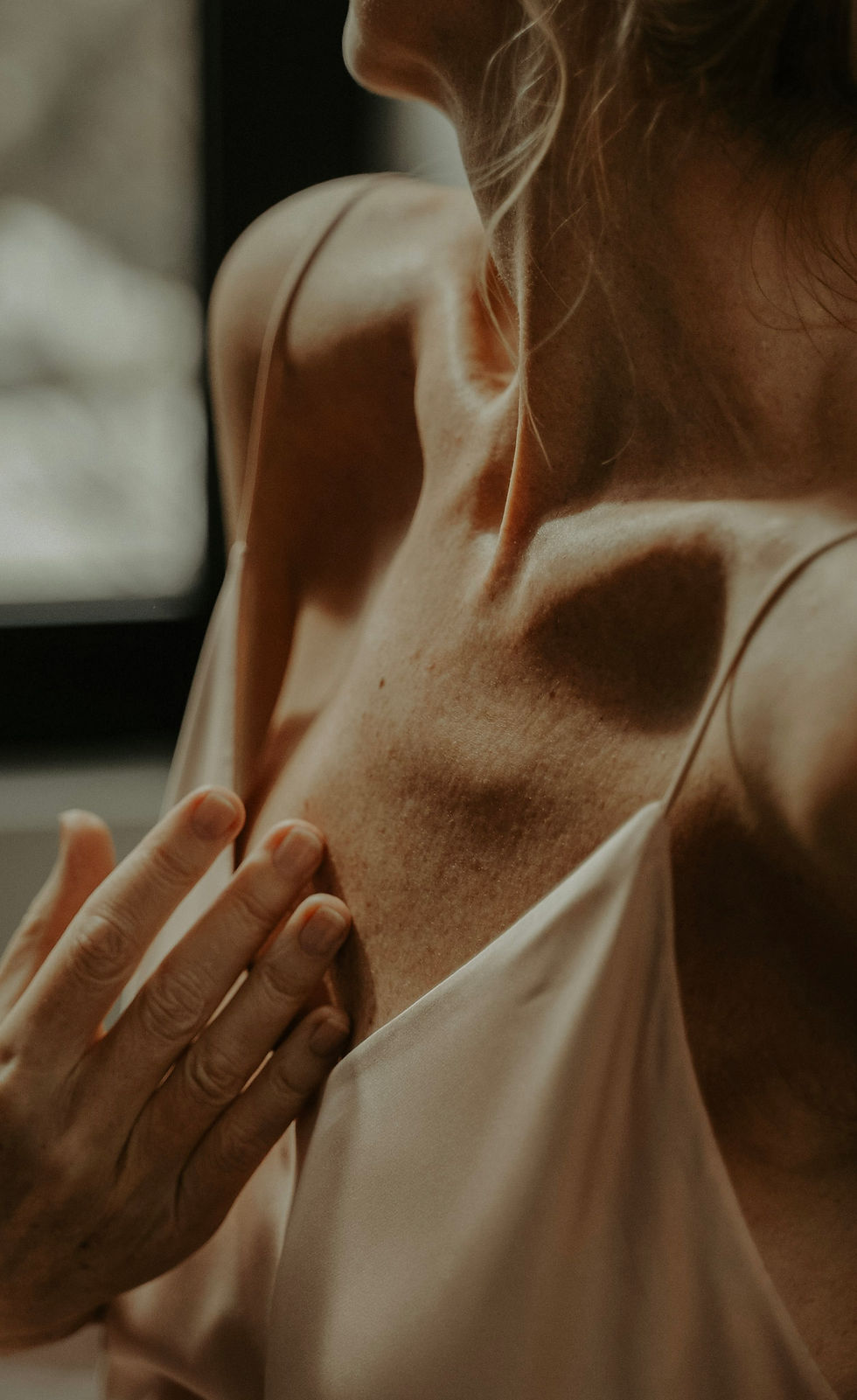 "Woman practicing somatic awareness with hands on heart for intuitive health"