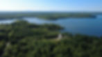 Southeast aerial view of a wooded Maine property
