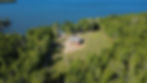 Aerial view of a Maine waterfront camp at sunset
