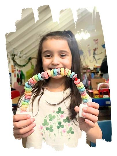 School age child displaying an art project