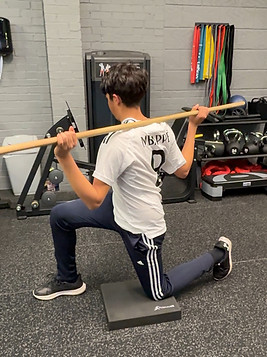 Junior golf fitness client warming up for his session
