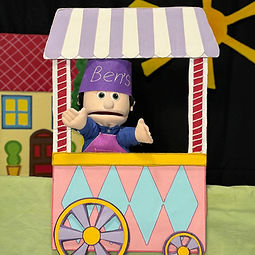 ice-cream man is selling the ica cream in mobile puppet theater