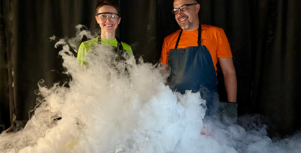 wo science presenters surrounded by thick fog from a liquid nitrogen experiment at a kids birthday party in Los Angeles