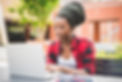 young-beautiful-black-woman-sitting-using-a-computer-tapping-on-the-keyboard-universit-SBI