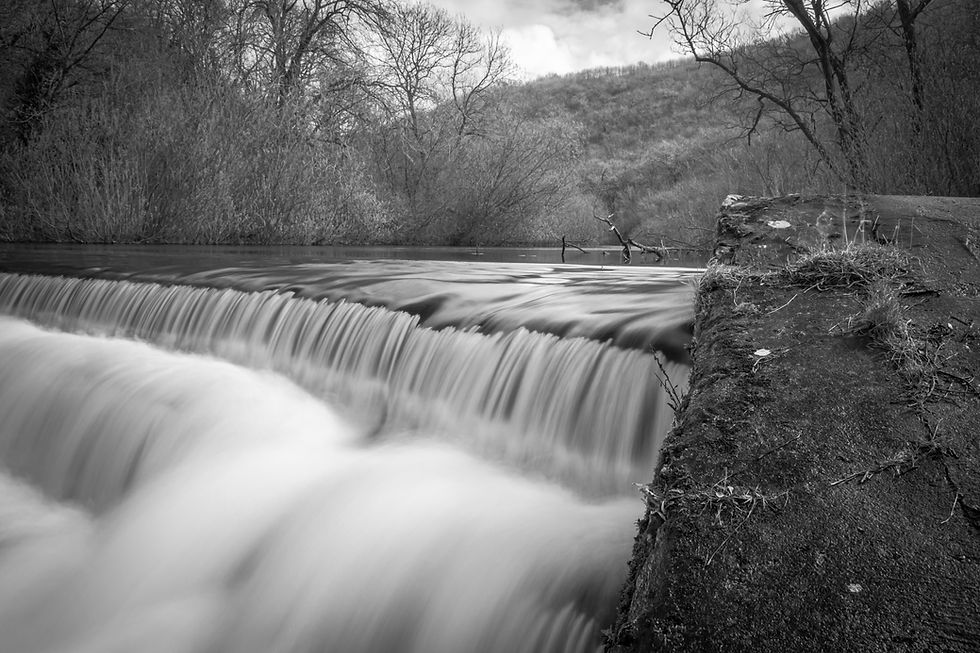 Long exposure of the Monsal Dale Weir waterfall on the Monsal Trail in the Peak District.j