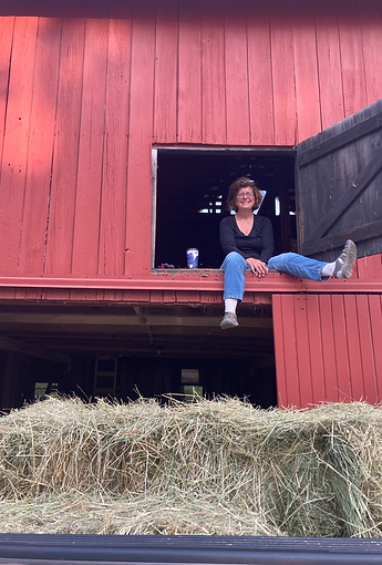 Dr K sitting in hayloft