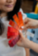 Woman reviewing red and orange color swatches