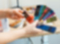 Hands holding fabric color swatches