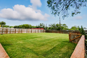Spacious grassy area, fenced backyard
