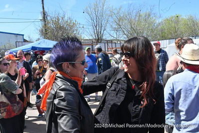 Two women smiling at an outdoor event in 2014.
