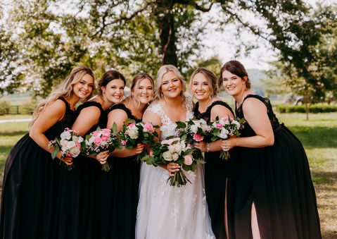 a bride and her bridesmaids pose for a photo