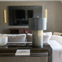 Custom console table styled with designer accessories overlooking a luxury media room in Tulsa.