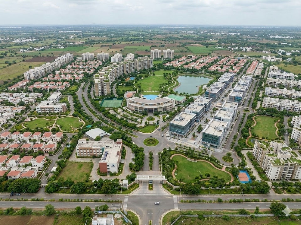 Aerial view of township with planned roads, green spaces, residential zones, and modern urban planning by Design Acrolect India