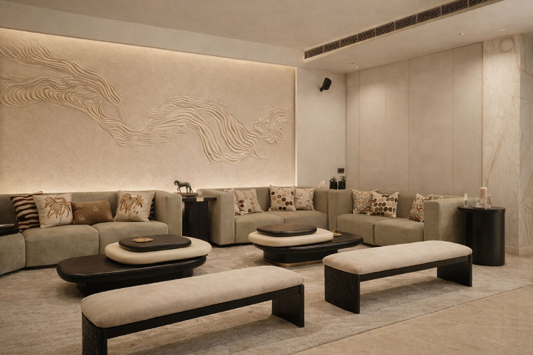 Minimal luxury living room interior with neutral tones, modern furniture, textured walls, and ambient lighting designed by Design Acrolect Gurgaon