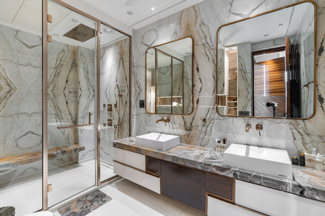 Luxury bathroom interior with marble finishes, glass partitions, modern fixtures, and premium interior design by Design Acrolect Gurgaon