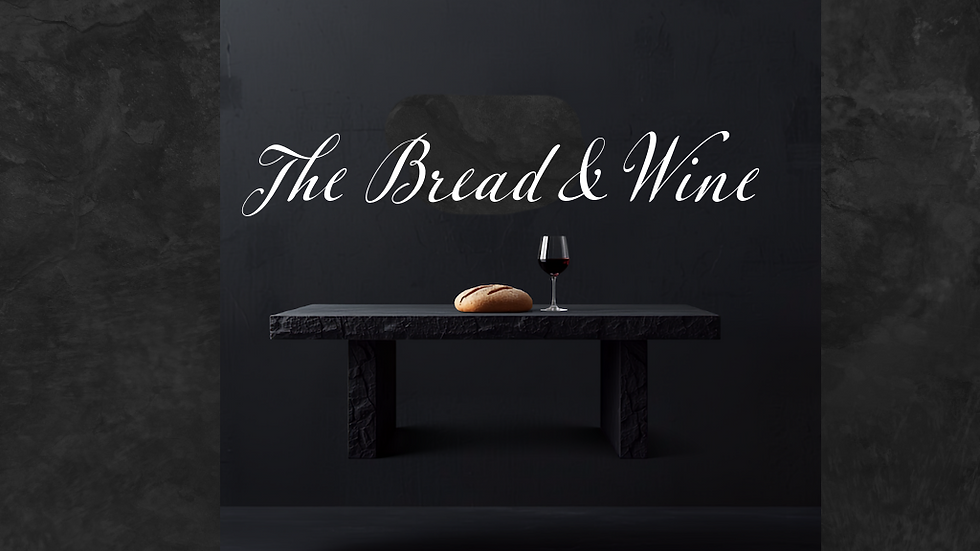 Wide landscape hero image with a dark stone table, bread loaf, and glass of wine