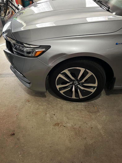 Large dent along body line on Honda Accord front left fender.