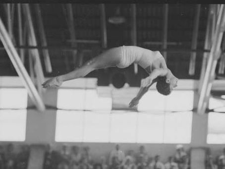 R Barton performs a reverse dive running at the Melbourne Olympics