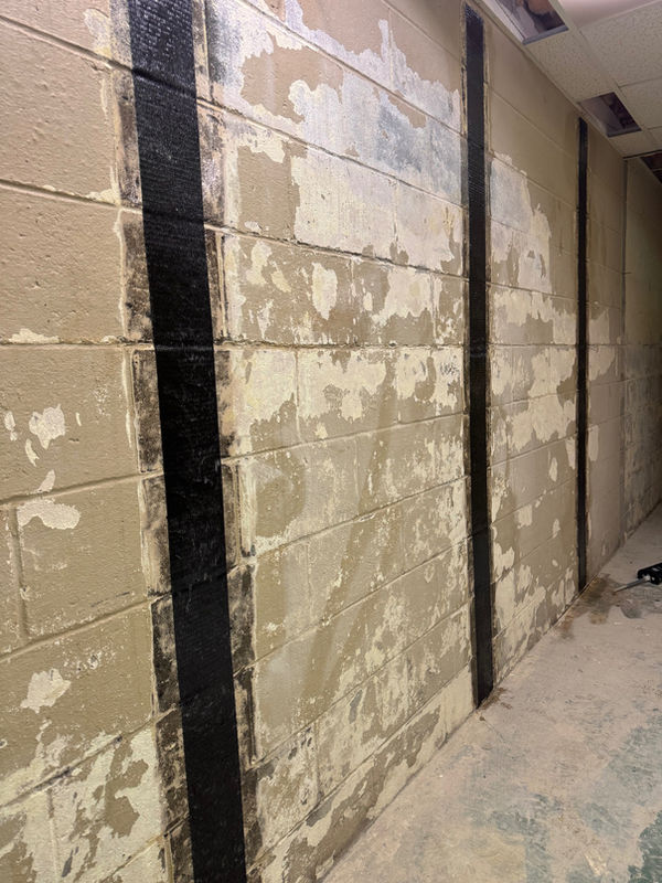 Carbon fiber straps on a block basement wall