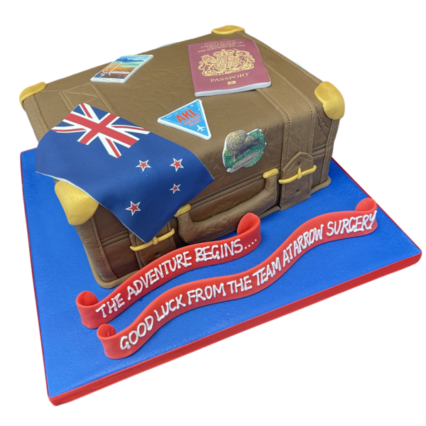 Bespoke suitcase-themed cake with edible travel stickers, locks, and handles in Solihull, West Midlands.