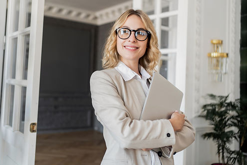 smiling-businesswoman-holding-a-laptop-standing-c-2025-02-25-05-49-54-utc_edited.jpg