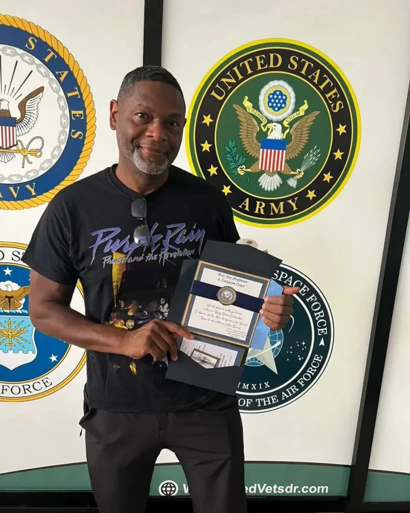 Happy-patient-showing-his-invitation-to-veterans-gala-819x1024