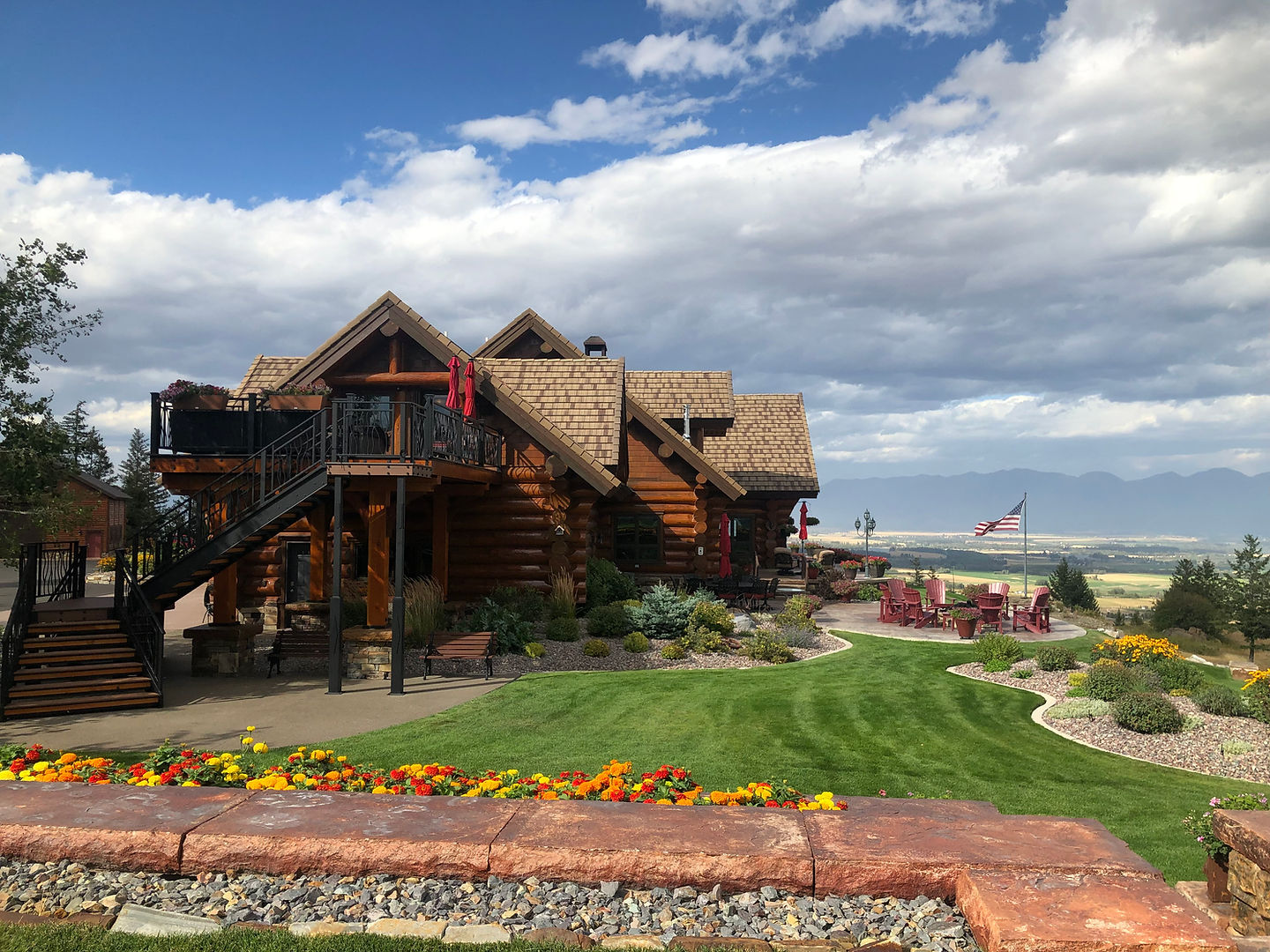 The log lodge above its summer gardens on the bluff
