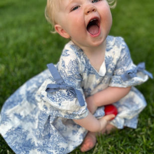 Baby in a toile dress