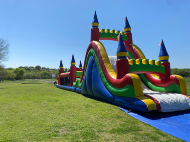 Spacious corporate event venue in Fort Worth, Texas, featuring modern amenities, a versatile layout, and a stage for live music, perfect for conferences, meetings, and special events. Bounce Houses