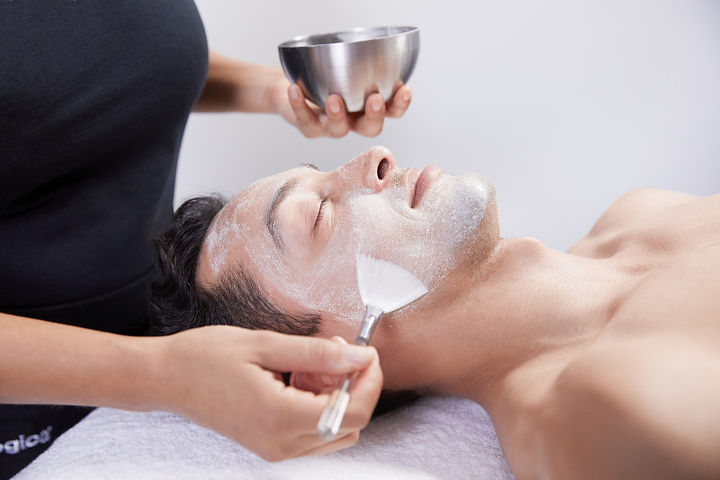 Applying Daily Microfoliant on male client.jpg