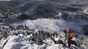 hunter looking out over a snow covered valley