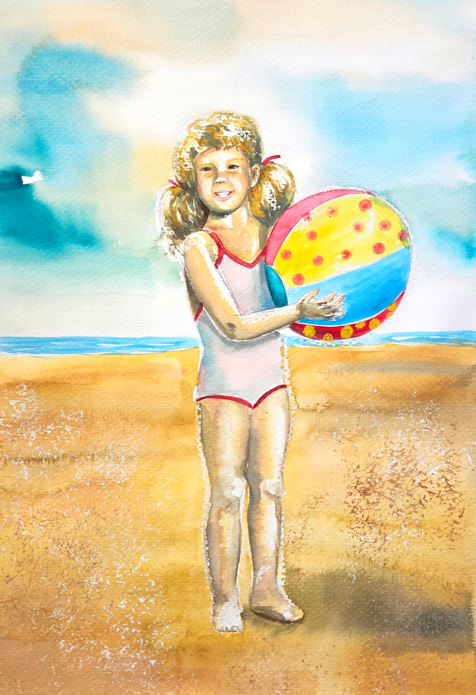 Girl with ball on the beach