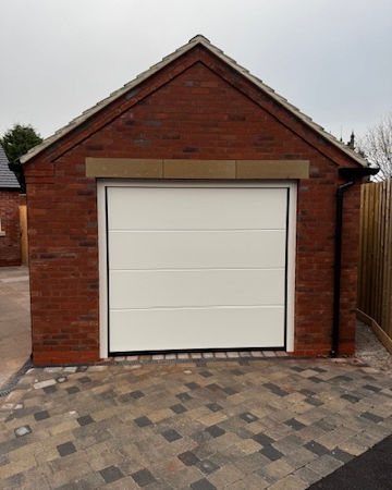 Electric insulated sectional garage door installed in Derby, Derbyshire. 