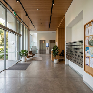 Foyer of an apartment building with natural light and showing the letter boxes
